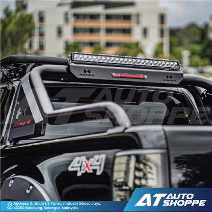Car roof rack with LED light bar on a vehicle, blurred background with 'AT Auto Shoppe' branding.