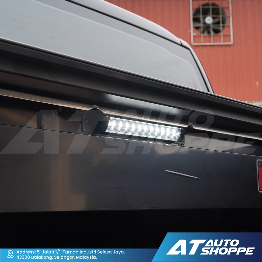 Car roof rack with LED light bar on a vehicle, brand 'AT Auto Shoppe' visible.