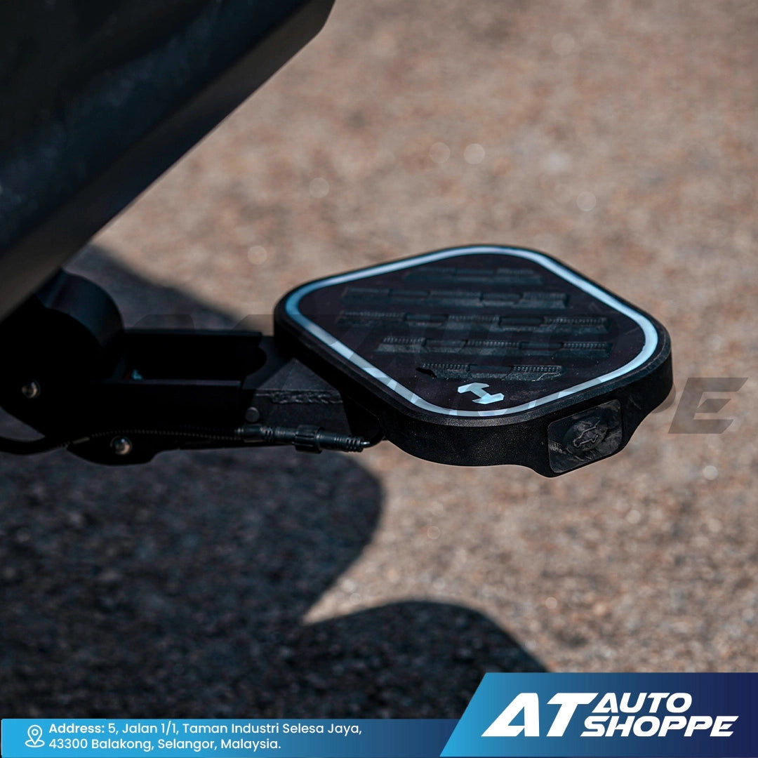 Close-up of a motorcycle mirror with 'AT Auto Shoppe' branding at the bottom.
