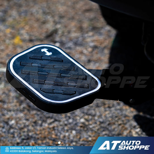 Black car step pad with tread pattern on a textured surface, featuring AT Auto Shoppe branding.