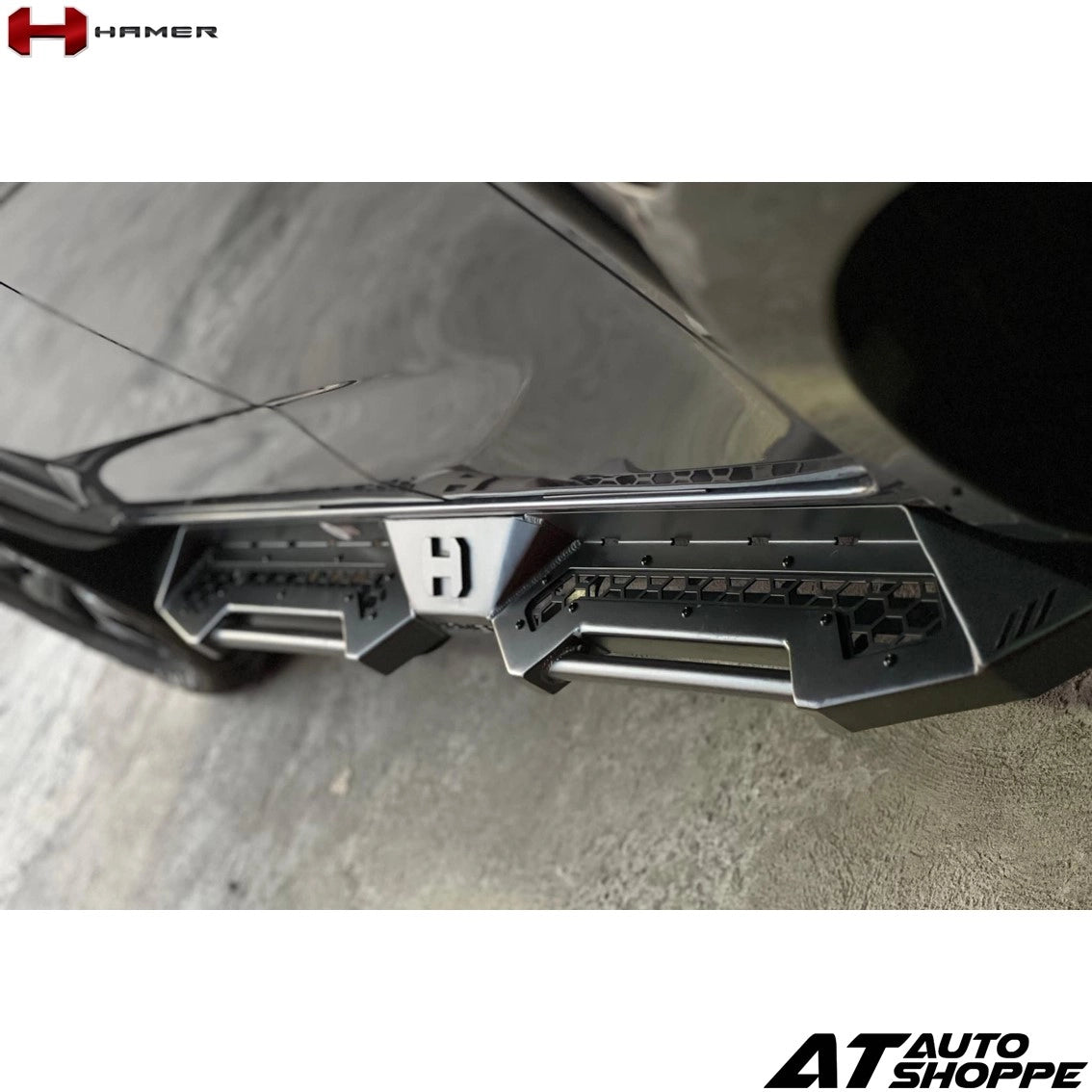 Close-up of a car bumper with a visible brand logo on a white background