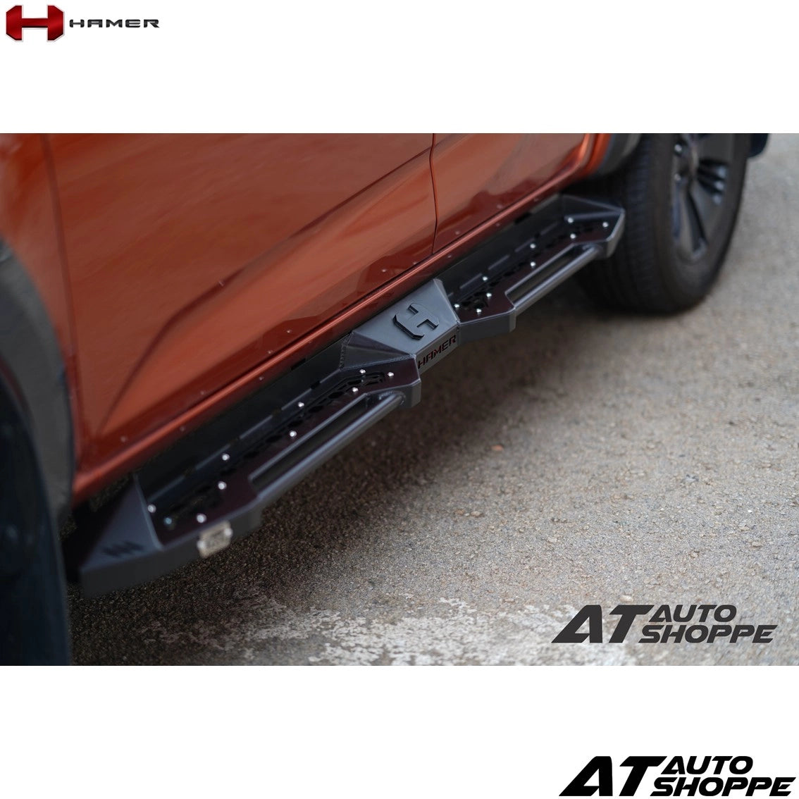 Close-up of a car's side step bar with 'Hamer' and 'AT Auto Shoppe' branding.