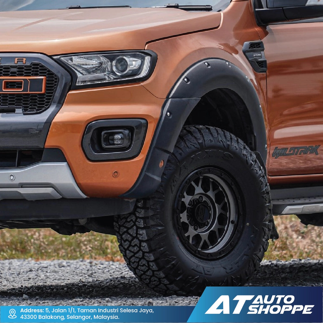 Close-up of an orange Ford Ranger truck with 'AT Auto Shoppe' branding.