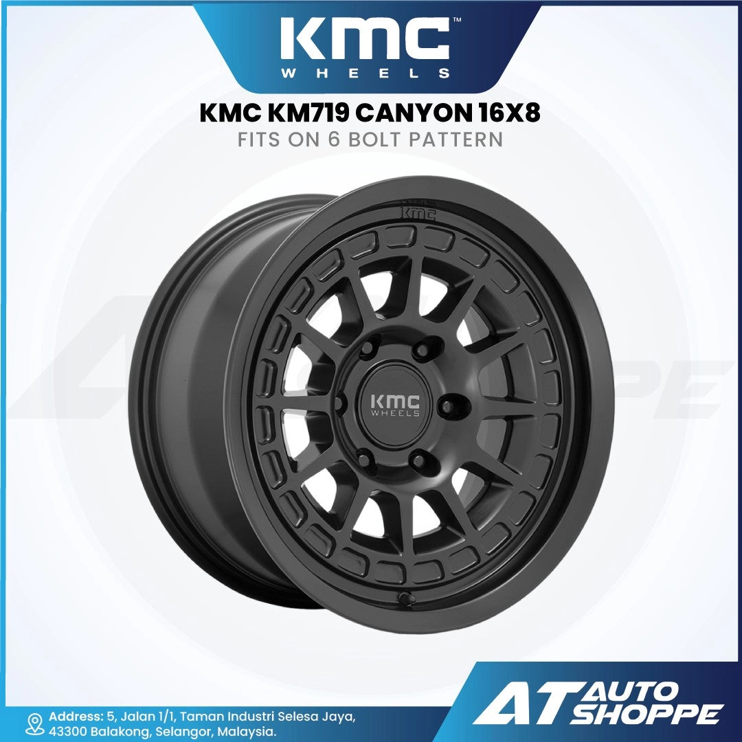 KMC KM719 Canyon wheel on a white background with KMC and AT Auto Shoppe branding.