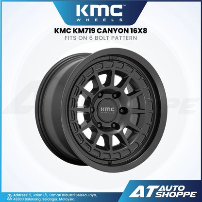 KMC KM719 Canyon wheel on a white background with KMC and AT Auto Shoppe branding.