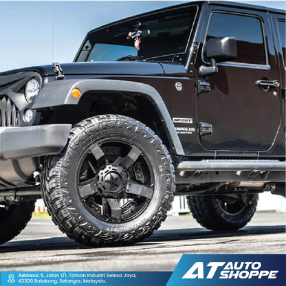 Black Jeep Wrangler withXD Wheels rims on a road, featuring AT Auto Shoppe branding.