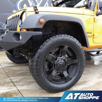 Yellow Jeep with black tire and rim on a concrete surface, featuring AT Auto Shoppe branding.