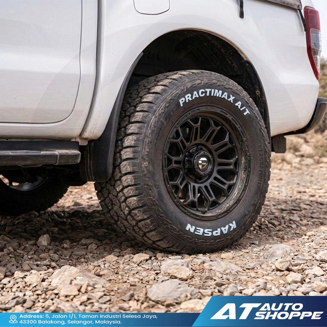 Off-road vehicle tire with KAPSEN branding on a rocky terrain, featuring 'AT Auto Shoppe' logo.