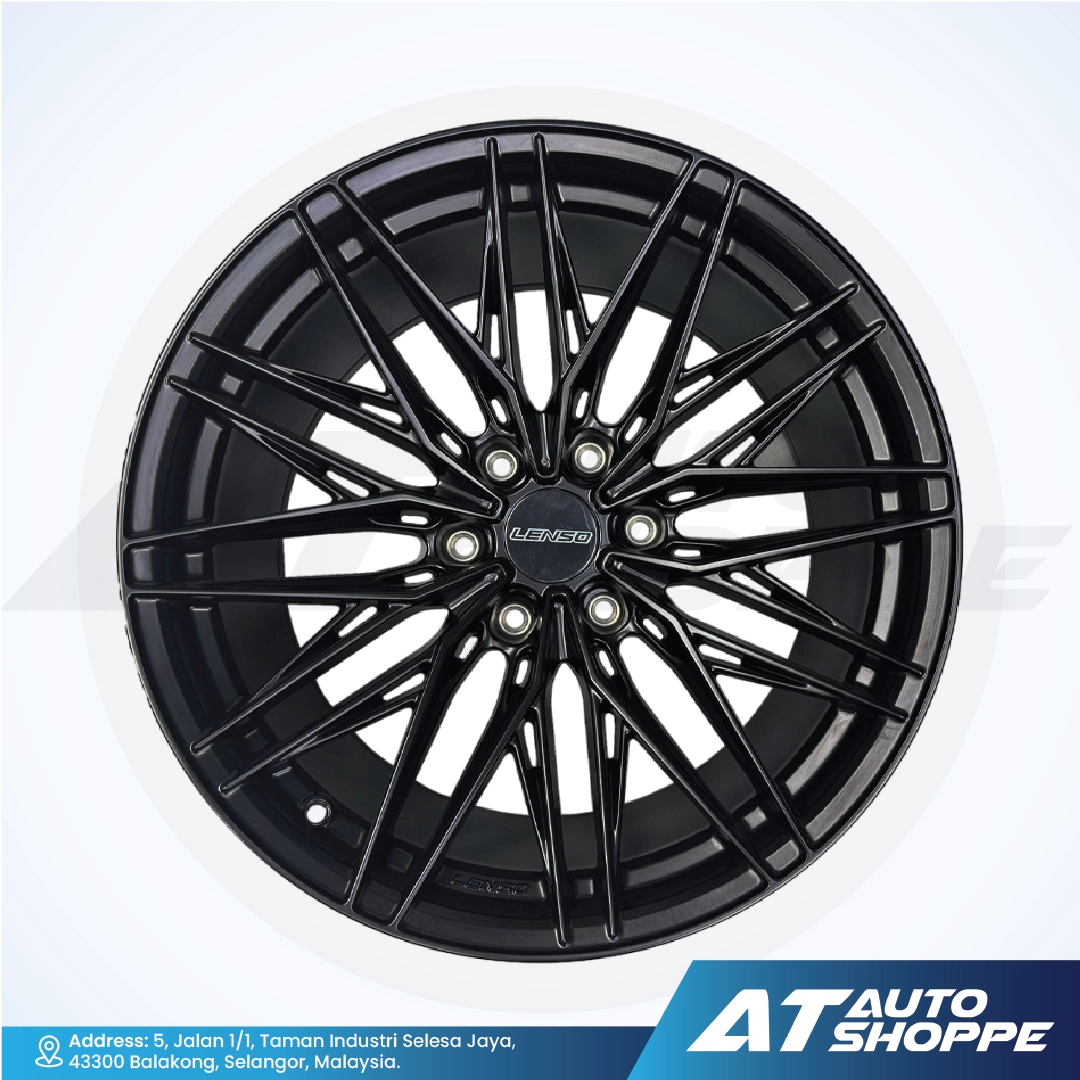 Black alloy wheel with 'AT Auto Shoppe' branding on a white background