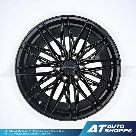 Black alloy wheel with 'AT Auto Shoppe' branding on a white background
