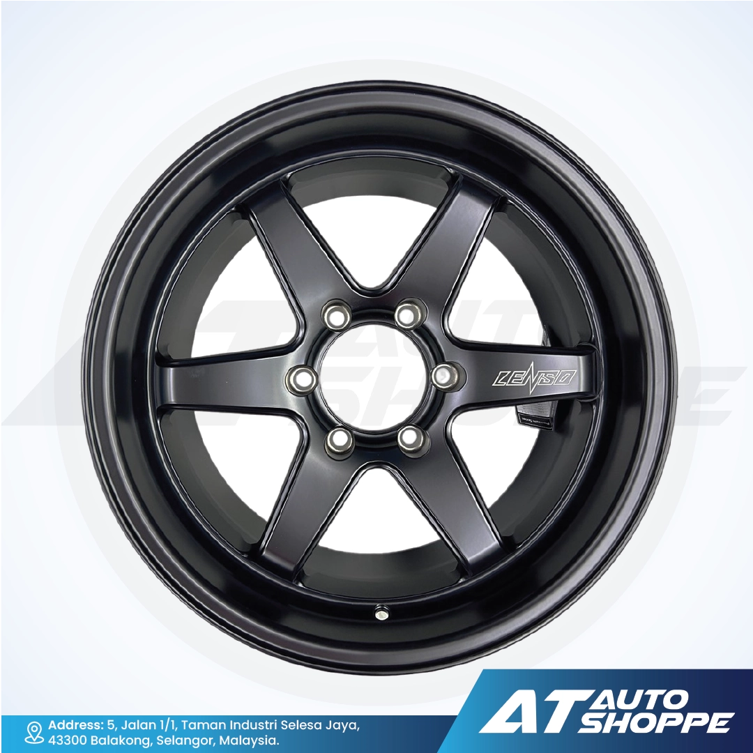 Black alloy wheel with 'AT Auto Shoppe' branding on a white background