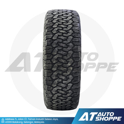 Tire with tread pattern on a white background, featuring AT Auto Shoppe branding.