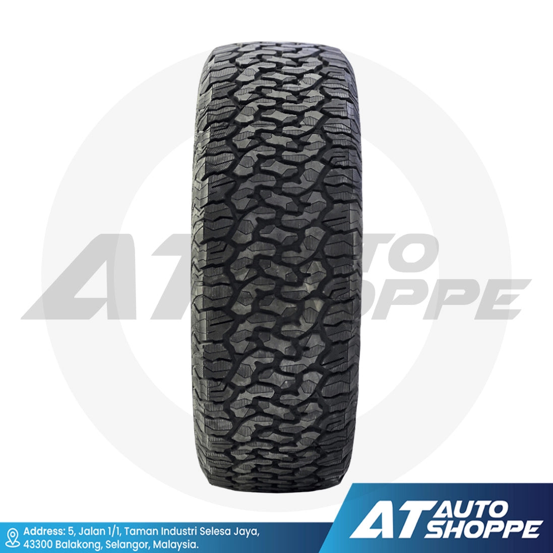 Tire with tread pattern on a white background, featuring AT Auto Shoppe branding.