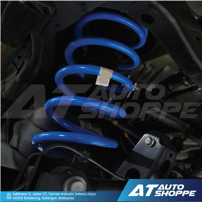 Lovells blue shock absorber on a car suspension system with AT Auto Shoppe branding.