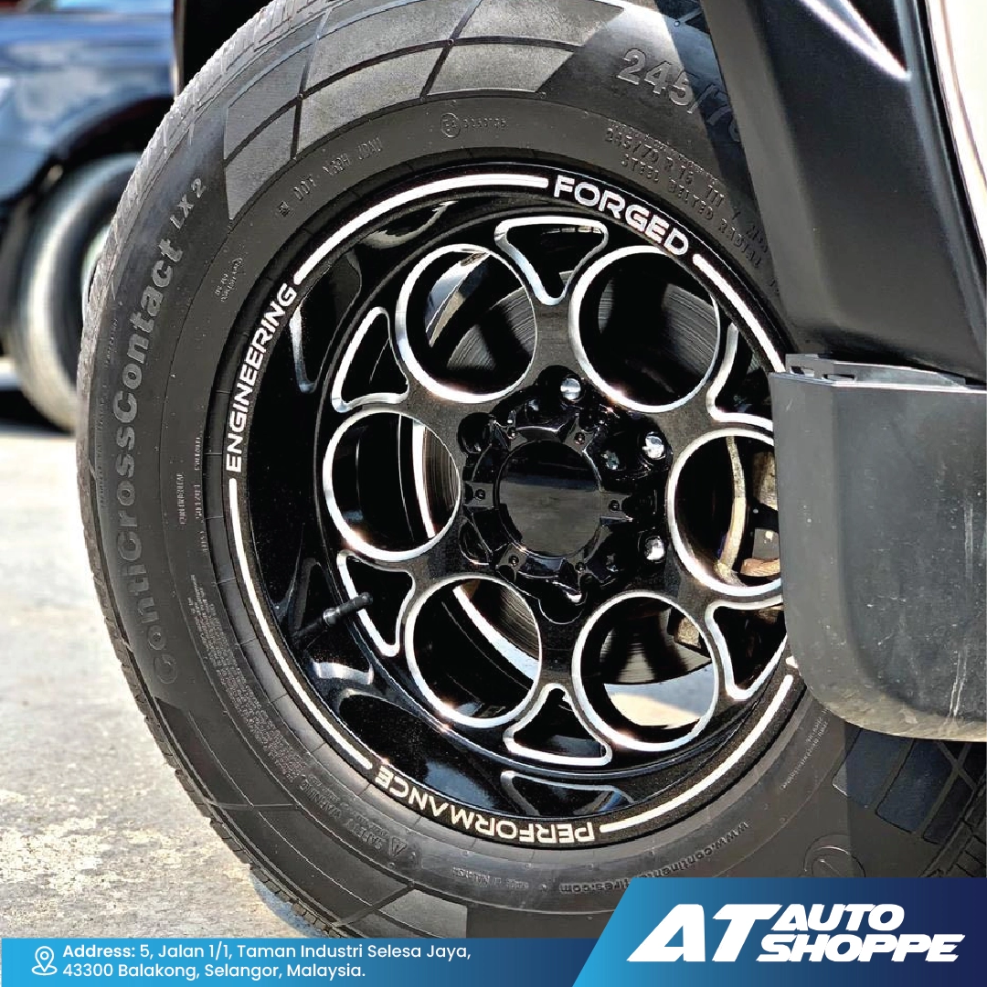 Close-up of a Monsterims wheel with 'AT Auto Shoppe' branding.