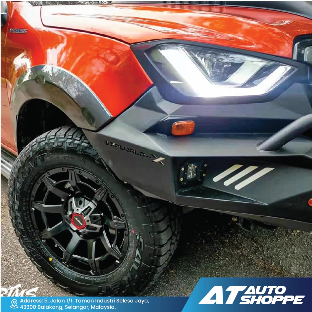 Close-up of a red SUV withMonsterims wheel and visible branding at AT Auto Shoppe.