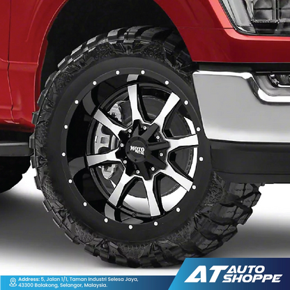 Close-up of a red vehicle with a black and silver wheel, featuring the AT Auto Shoppe logo.
