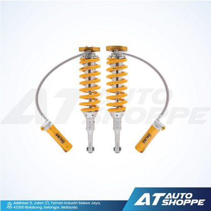 Ohlins shock absorbers with yellow springs on a white background, featuring the AT Auto Shoppe logo.