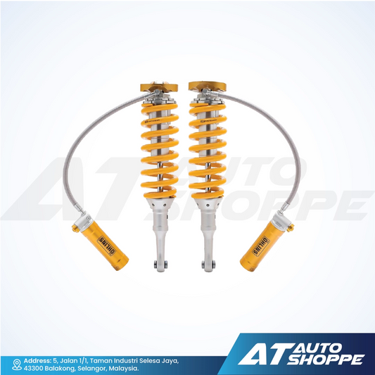 Ohlins shock absorbers with yellow springs on a white background, featuring the AT Auto Shoppe logo.