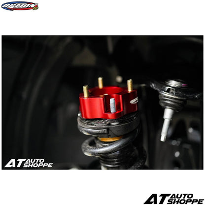 Close-up of a red mechanical component on a black background with 'AT Auto Shoppe' branding.