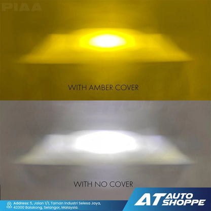 Comparison of LED light with amber cover and without cover on a gradient background, featuring PIAA and AT Auto Shoppe branding.