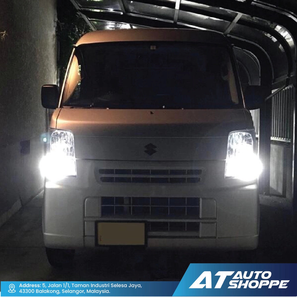 Van with illuminated headlights in a dark setting, likely showcasing headlight brightness.