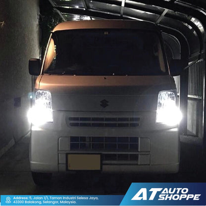 Van with illuminated headlights in a dark setting, likely showcasing headlight brightness.