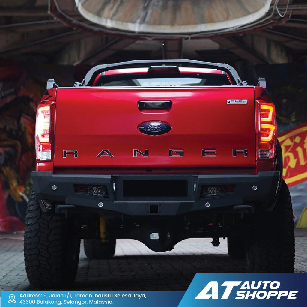 Red Ford Ranger truck in a garage with visible branding of AT Auto Shoppe.