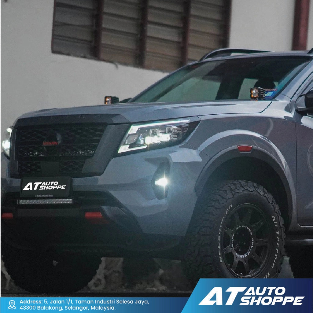 Gray SUV with 'AT Auto Shoppe' branding on a blurred background