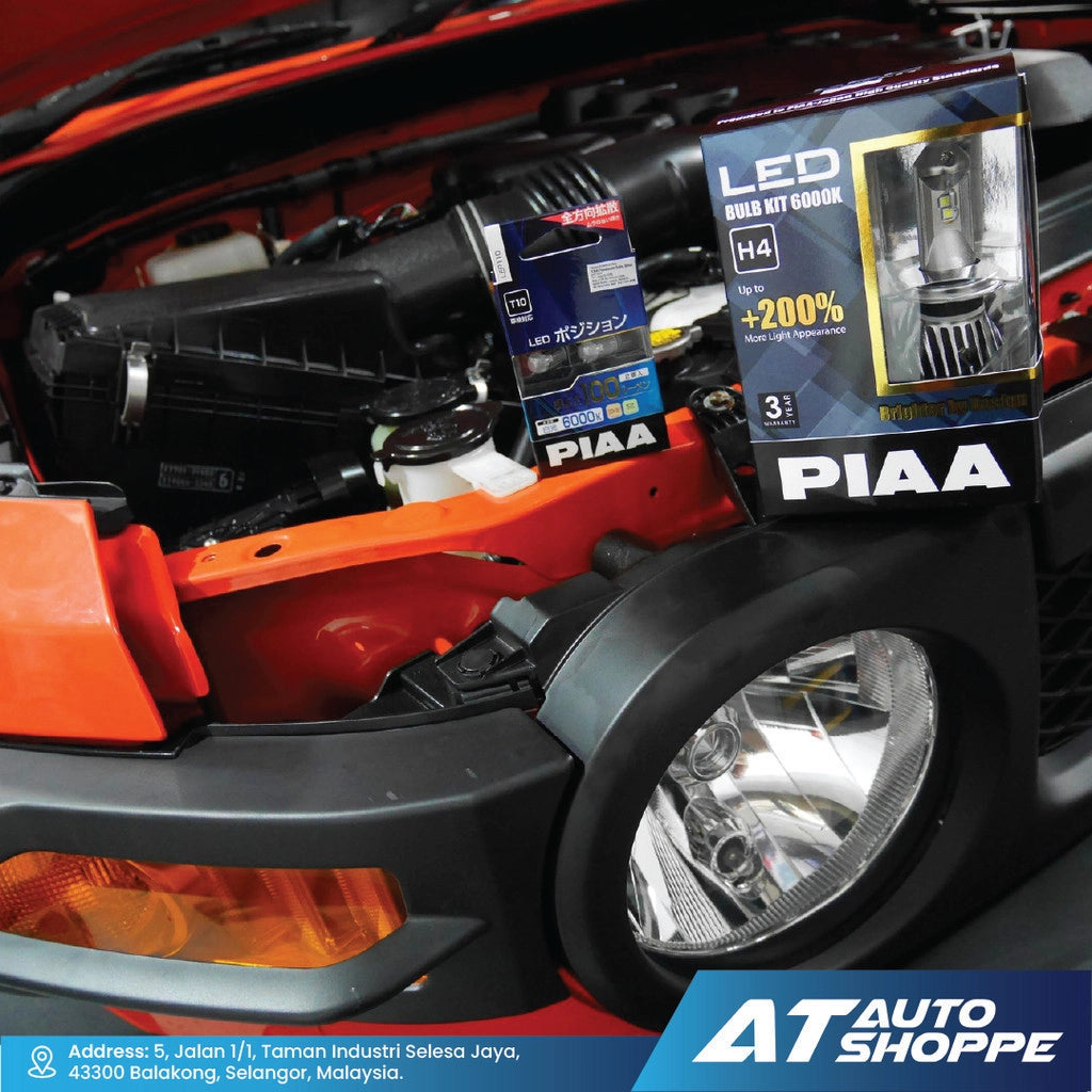 PIAA LED light bulbs in a car's open hood with visible branding.