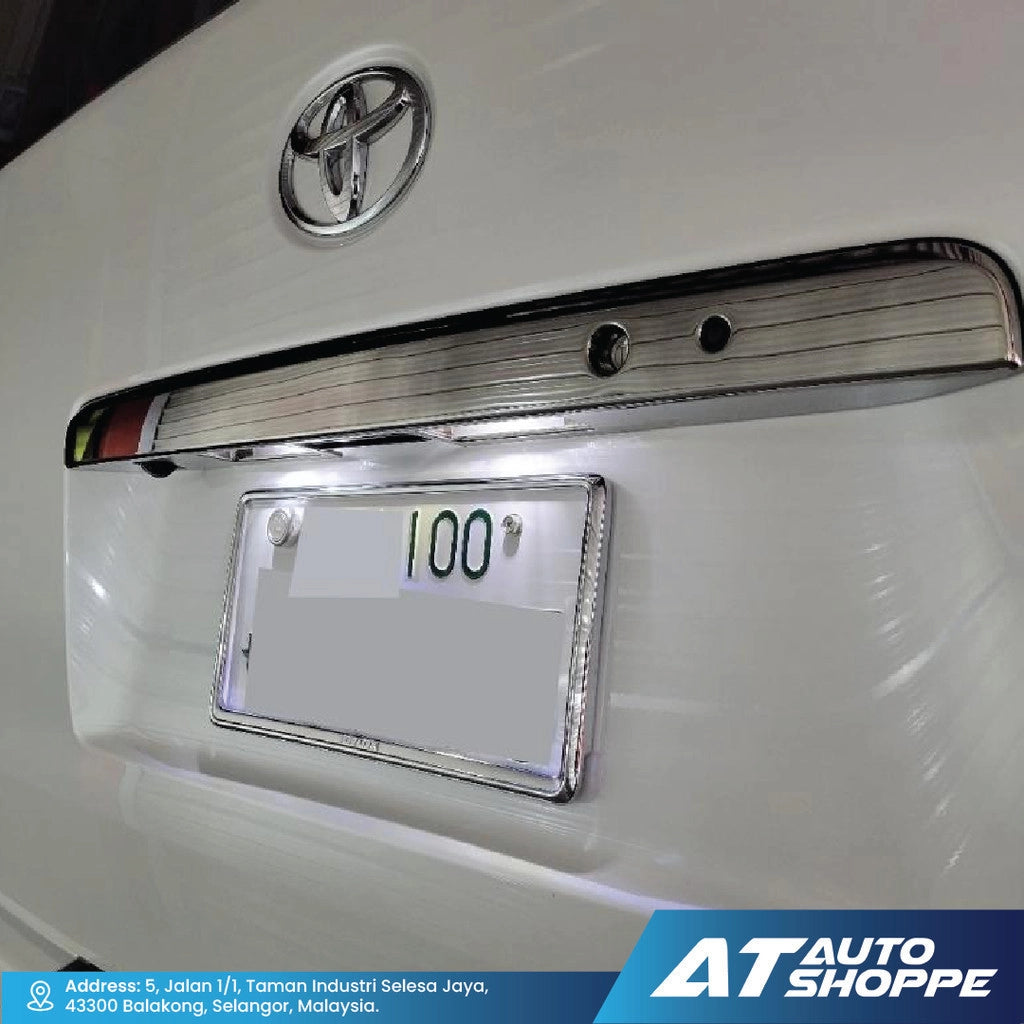 Close-up of a Toyota vehicle with a chrome bumper and license plate holder.