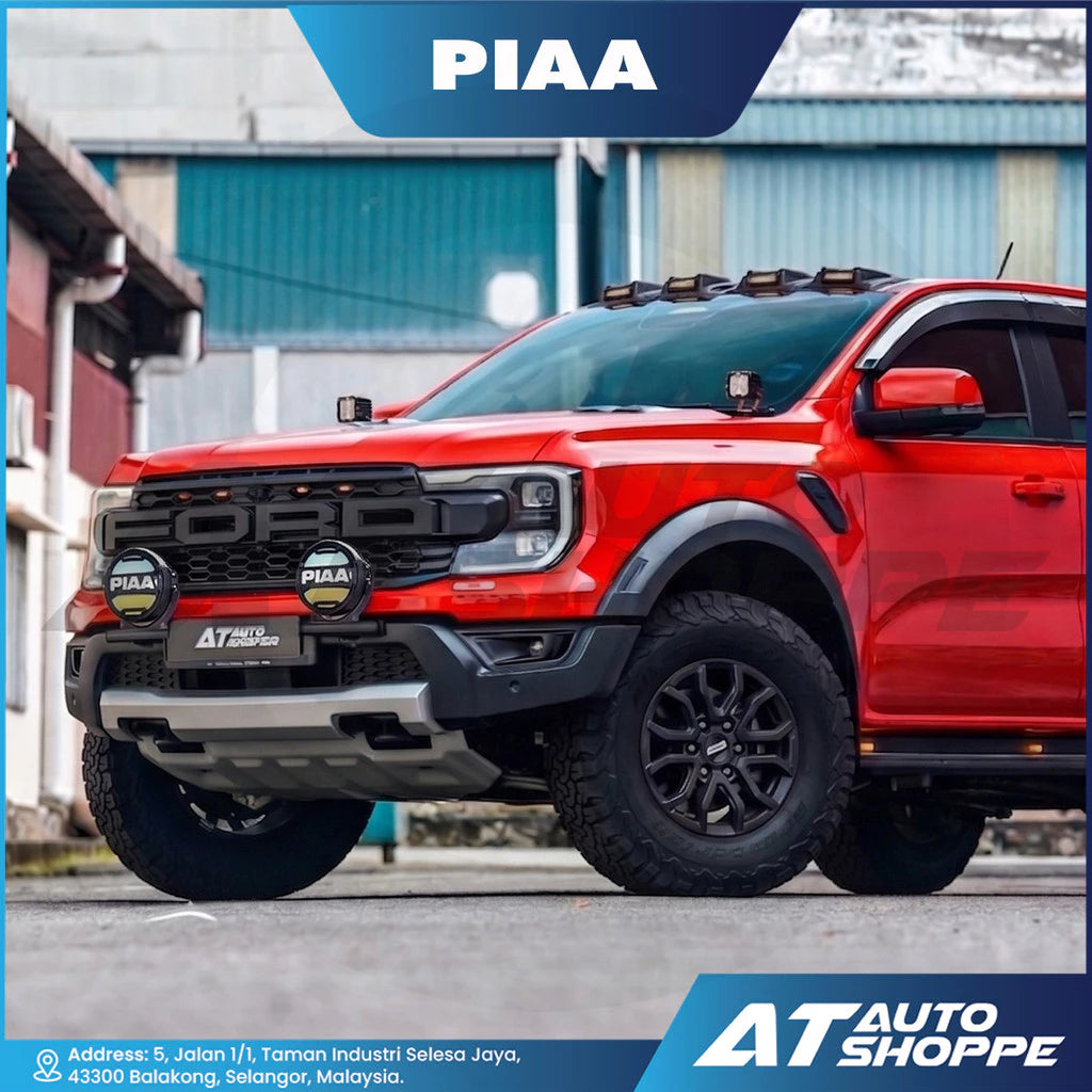 Red pickup truck with PIAA and AT Auto Shoppe branding on a blurred background