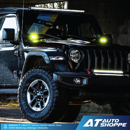 Black Jeep Wrangler with additional lights on a dark background, featuring AT Auto Shoppe branding.
