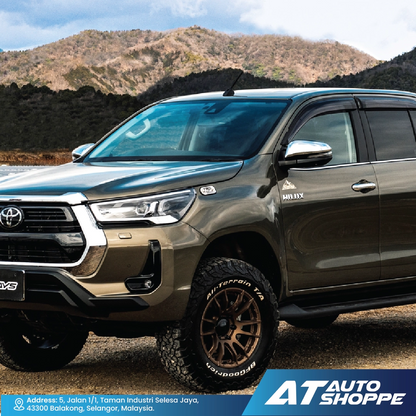 Toyota SUV parked in a mountainous area with 'AT Auto Shoppe' branding.