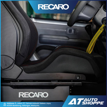 Car seat with Recaro branding inside a vehicle, featuring AT Auto Shoppe logo.