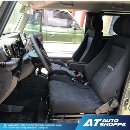 Car interior with black seats and dashboard, showing the brand 'AT Auto Shoppe'.