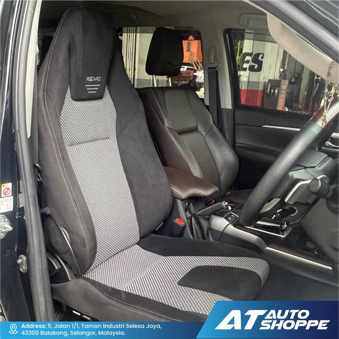 Recaro car interior with grey and black seat covers, showing the steering wheel and dashboard.