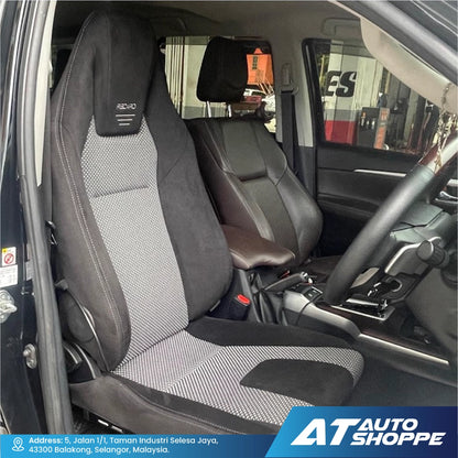 Recaro car interior with grey and black seat covers, showing the steering wheel and dashboard.