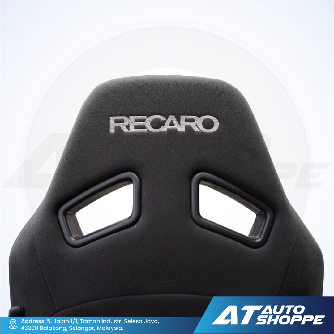 Black car seat with Recaro branding on a white background, featuring AT Auto Shoppe logo.