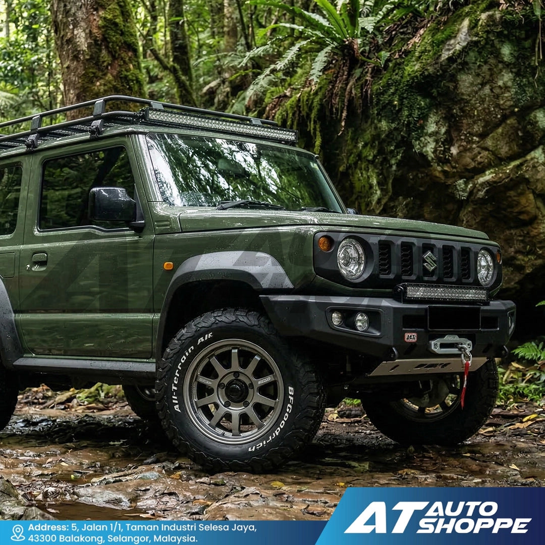 GreenSuzuki Jimny in a forest setting with 'AT Auto Shoppe' branding.