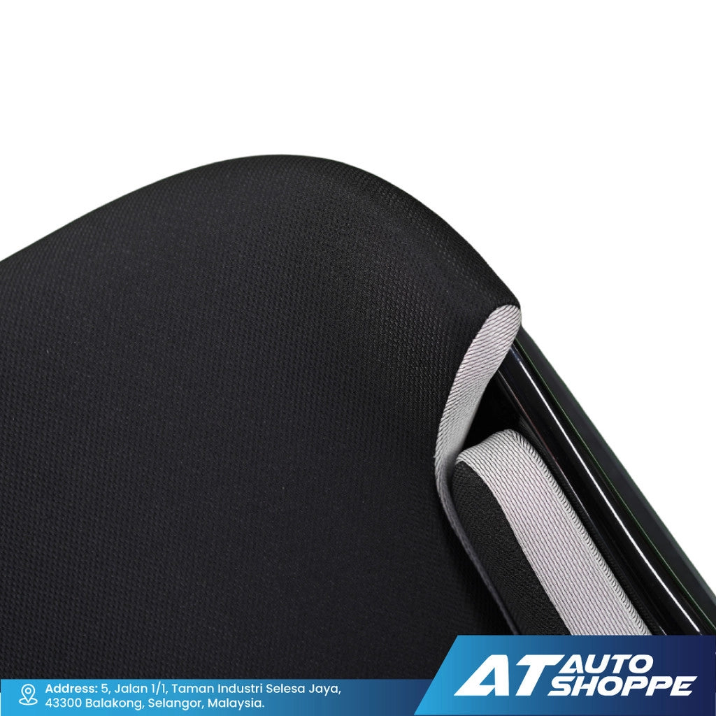Close-up of a car seat with a black cover and silver trim, featuring the AT Auto Shoppe logo.
