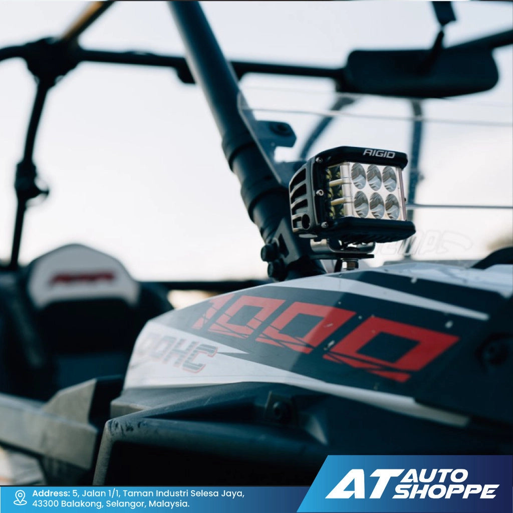 Rigid Industries light mounted on a vehicle with AT Auto Shoppe branding.