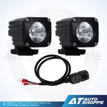 Two off-road Rigid lights with wiring harness on a white background, featuring the AT Auto Shoppe logo.