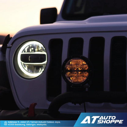 Close-up of Rigids headlight and fog light with 'AT Auto Shoppe' branding.