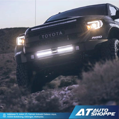Toyota truck on a dirt road with 'AT Auto Shoppe' branding at the bottom.