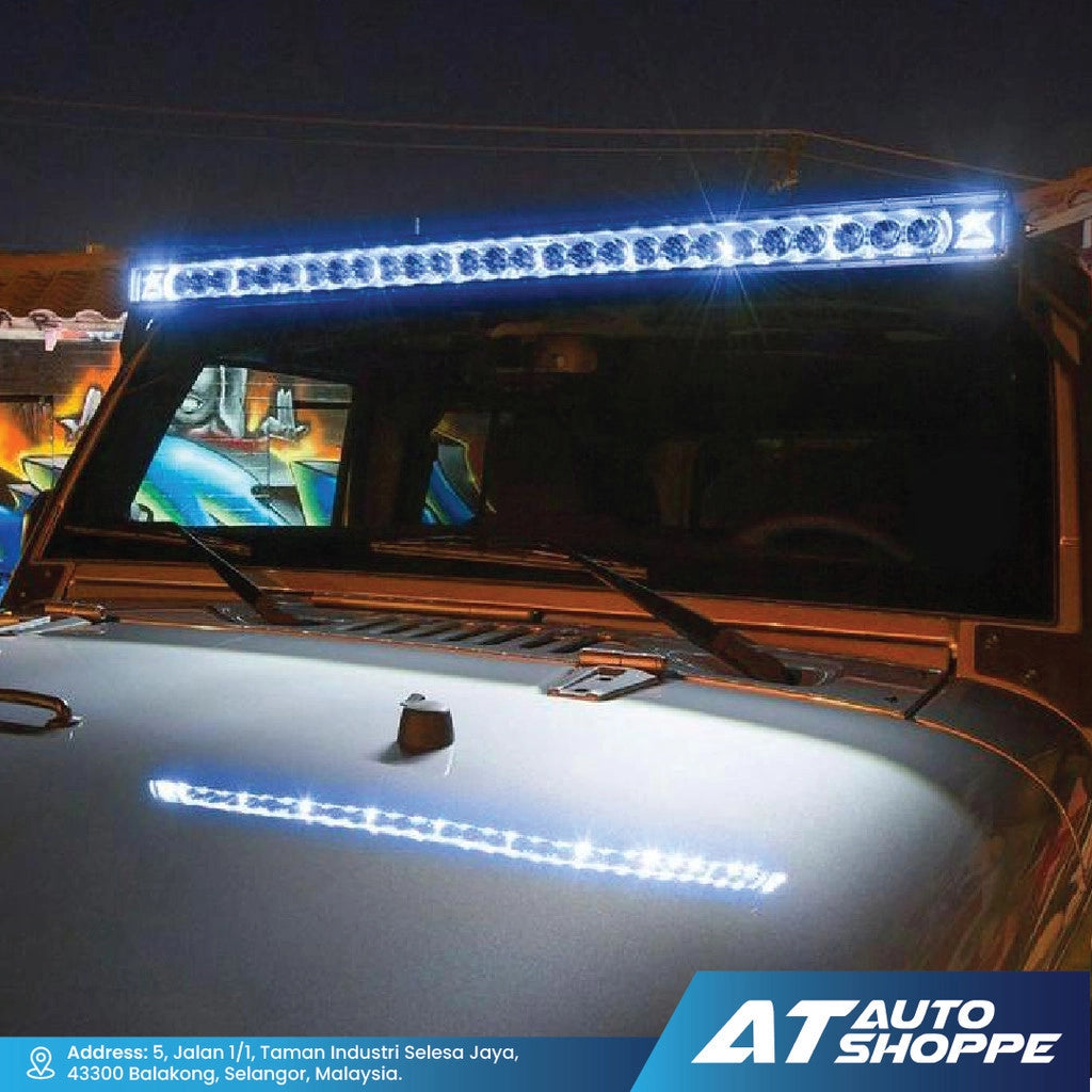 Car with a Rigid LED light bar on the roof at night, featuring AT Auto Shoppe branding.