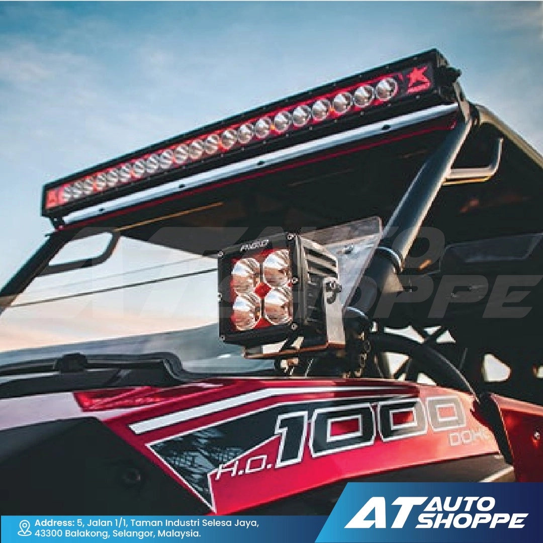 Off-road vehicle with additional lights on a clear sky background, featuring AT Auto Shoppe branding.
