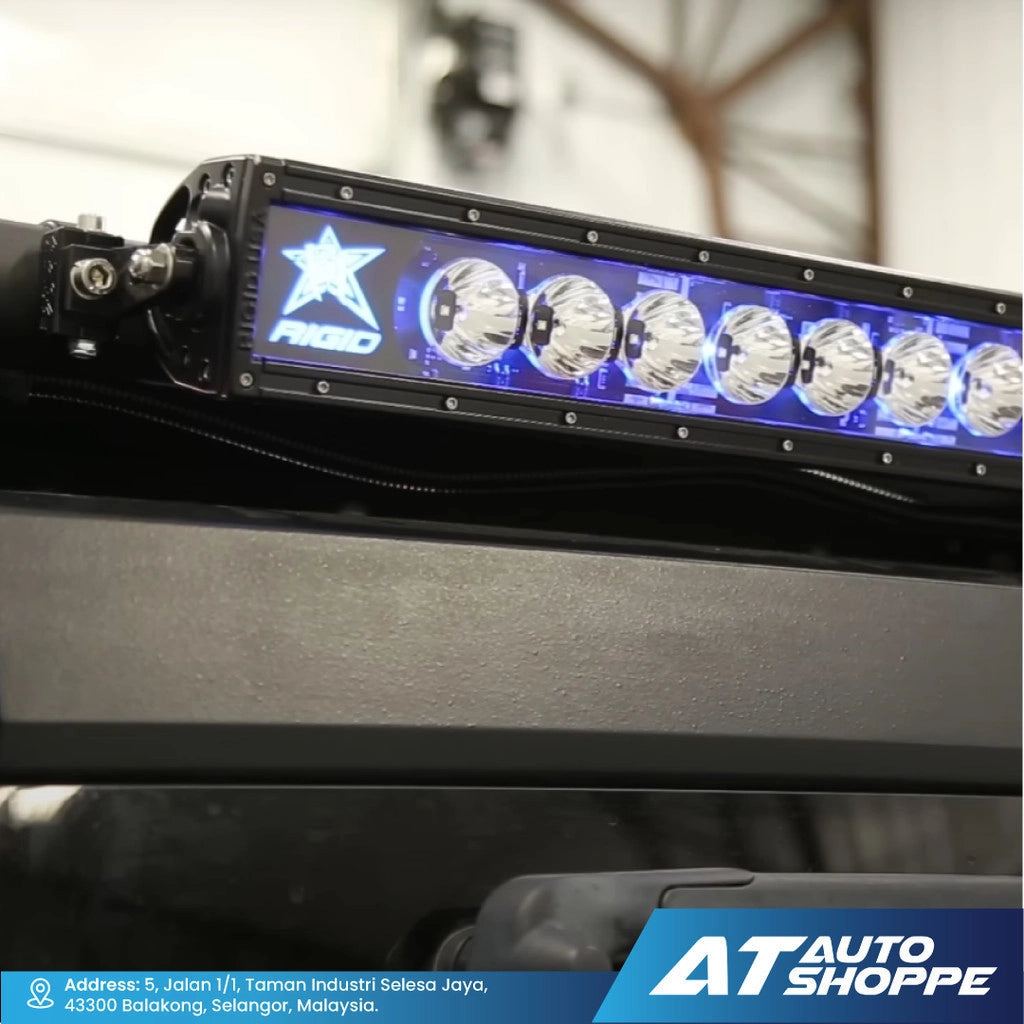 LED light bar with Rigid branding on a vehicle dashboard, featuring 'AT Auto Shoppe' logo.