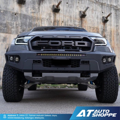 Front view of a Ford truck with a rugged design against a concrete wall.
