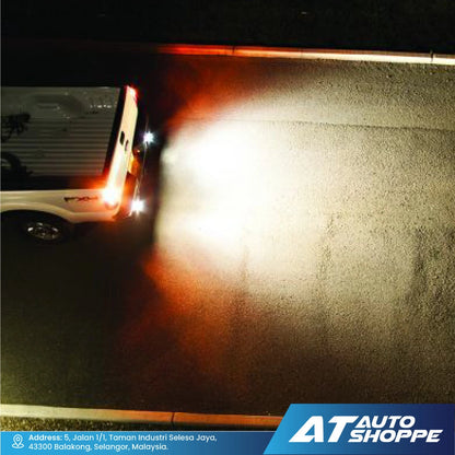 Car driving on a road at night with Rigid headlights on, showing a blurred background.